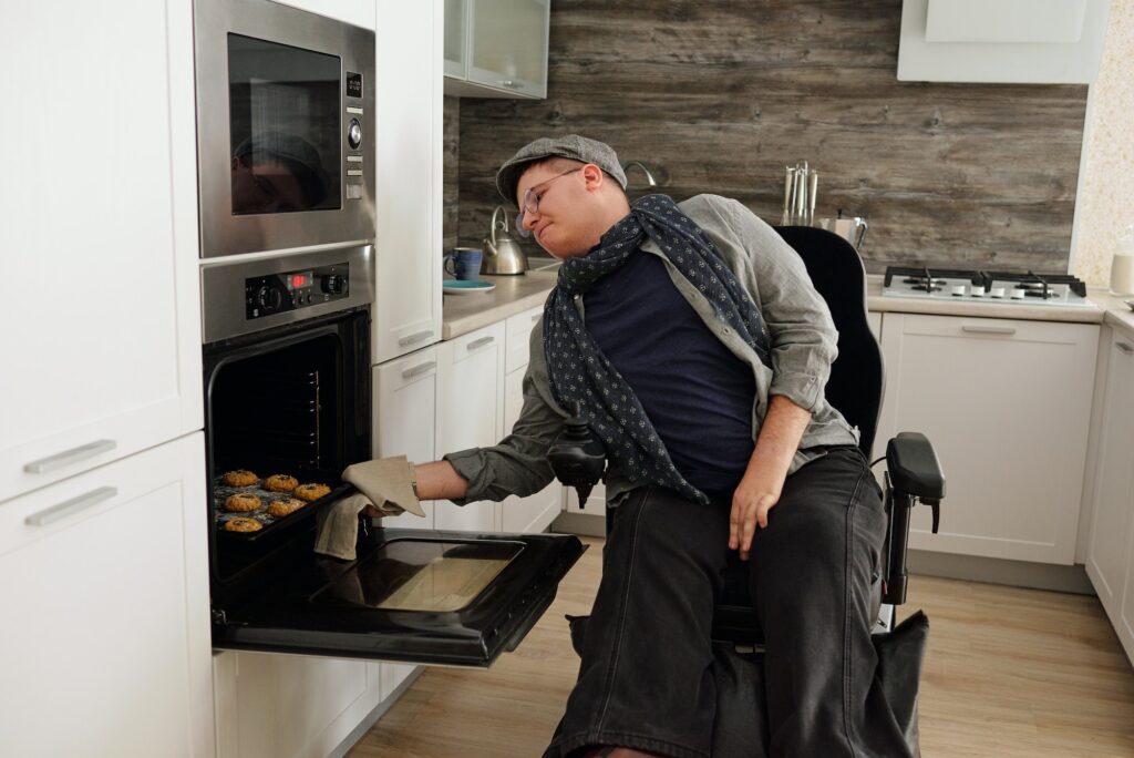Contemporary man with disability baking cookies