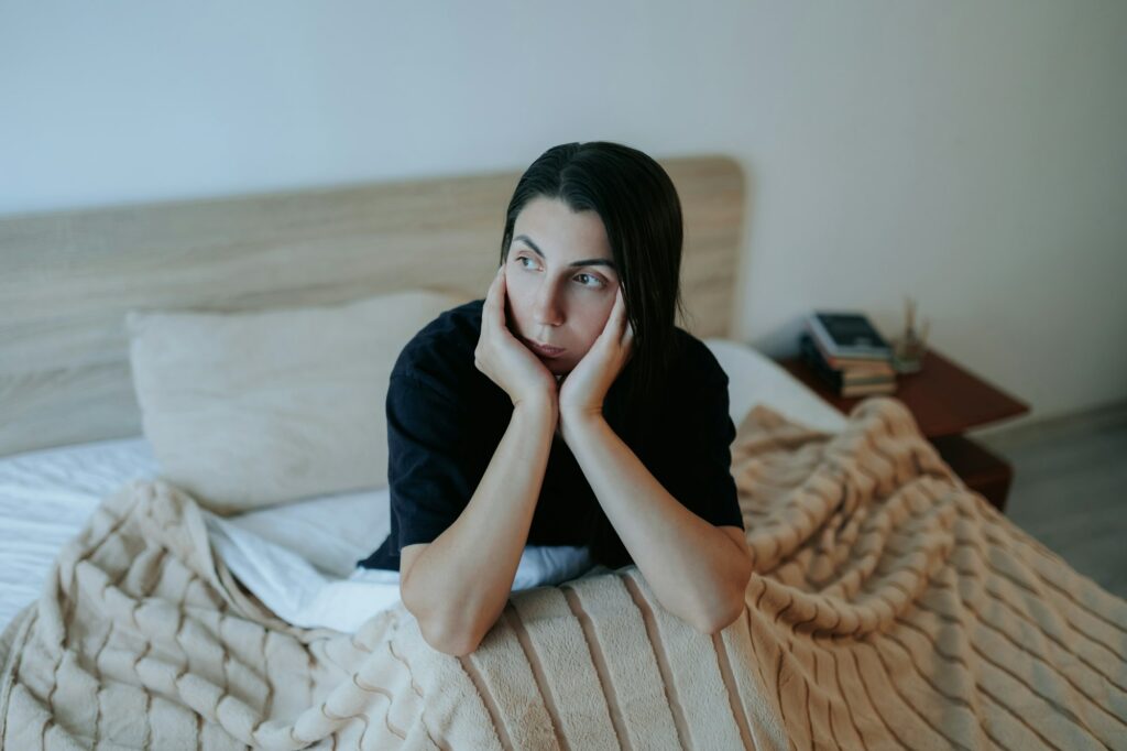 Woman with Depression Sitting Alone in Bedroom, Nighttime Sadness